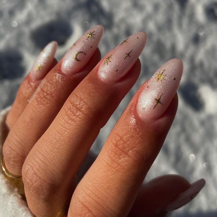 Ethereal Celestial Nail Design with Shimmering Pink and Gold Accents.