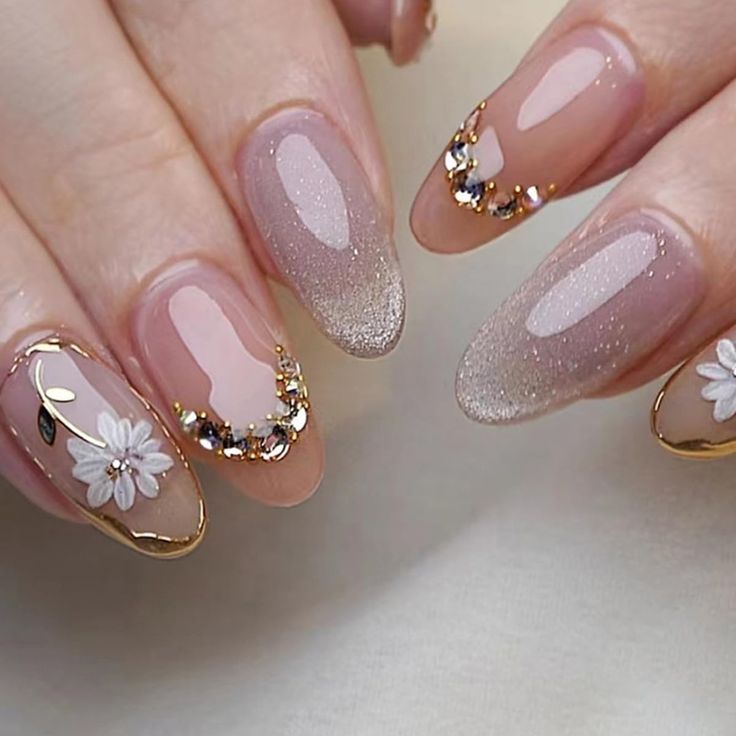 Sophisticated Floral Nail Design with Nude Base and Gold Accents.