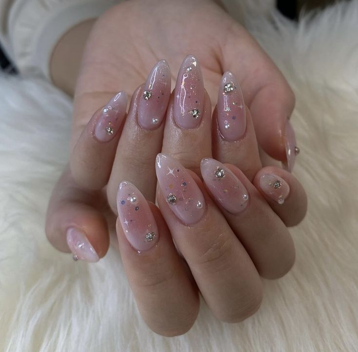 Chic Pink Ombre Stiletto Nails with Elegant Silver Accents and Gems.