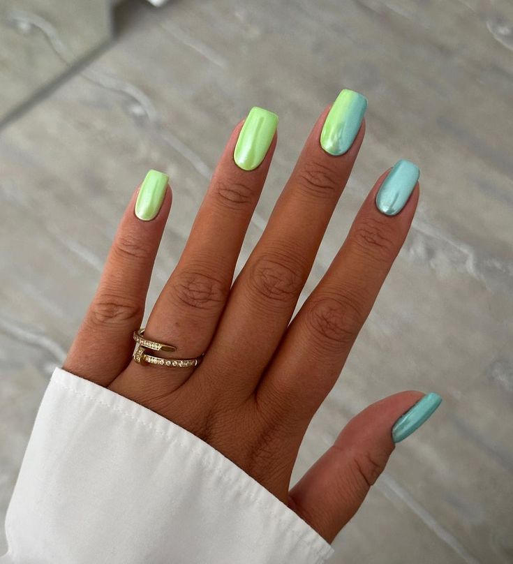 Playful Pastel Nail Design: Glossy Green and Blue Shades for a Trendy Spring/Summer Look.