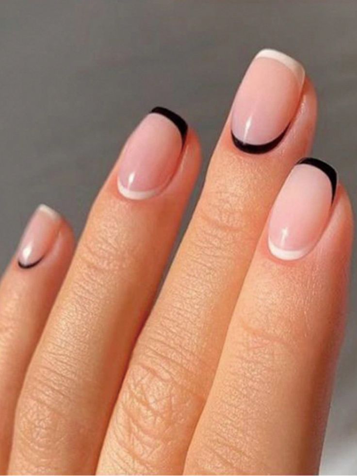 Chic Nail Design: Modern French Tips with Soft Nude Base and Bold Black Accents.