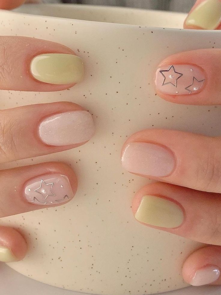 Chic Pastel Nail Design with Olive Green, Nude, Shimmery Pink, and Silver Star Accents.