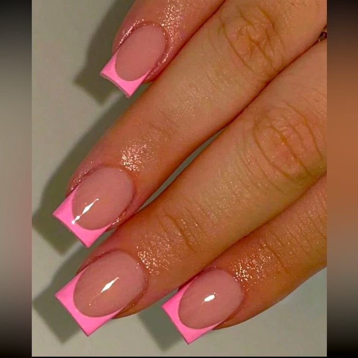 Modern French Tip Nail Design: Elegant Nude Base with Vibrant Pink Tips.