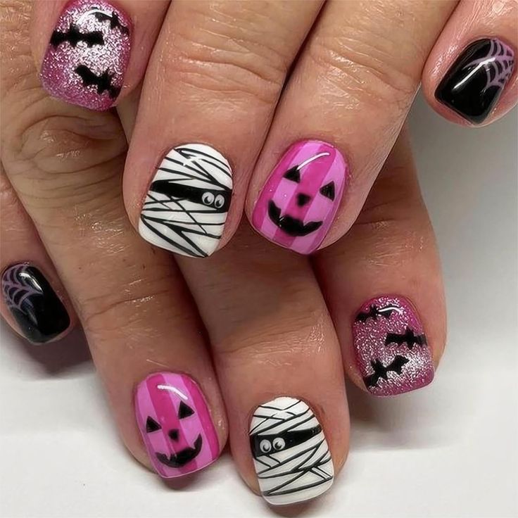 Vibrant Halloween Nail Art with Pumpkins, Mummies, and Bats