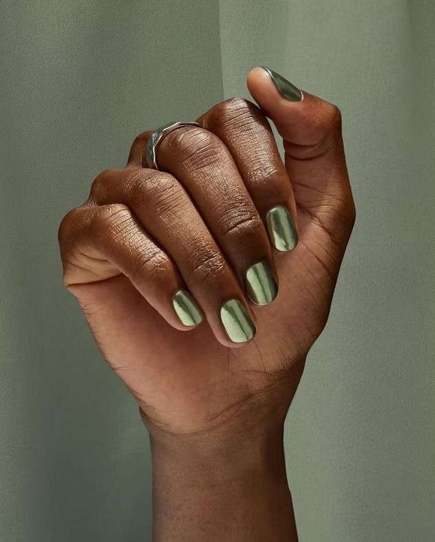 Chic Metallic Nail Design: Reflective Green and Muted Tones for Sophisticated Elegance.