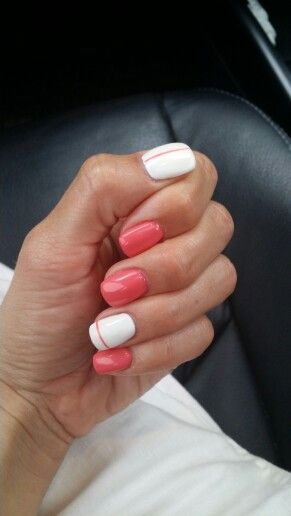 Cheerful Coral and White Nail Design: A Playful and Sophisticated Look.