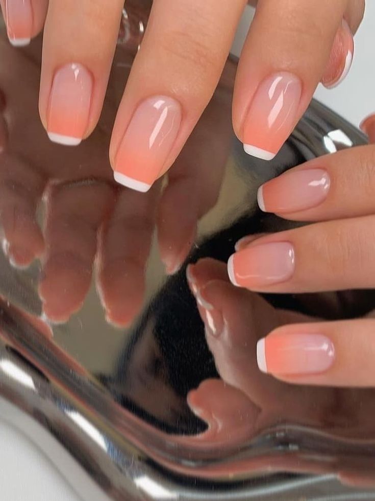 Elegant Ombre Peach to White Tip Nail Design with Glossy Finish.