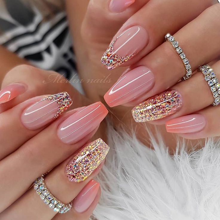 Elegant Nude Nail Design with Ombre Pink Glitter and Sophisticated Accents.