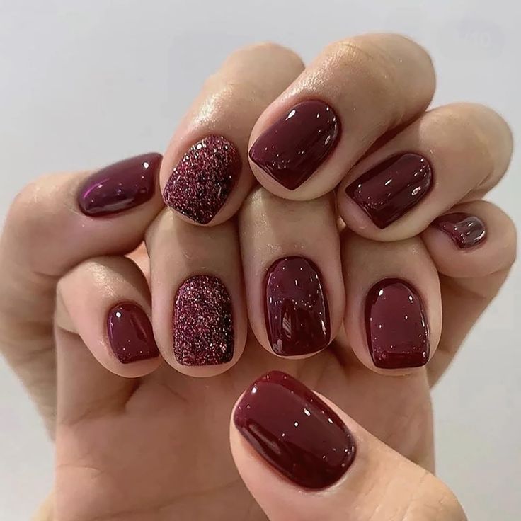 Elegant Burgundy Nails with Glossy and Glitter Finishes for a Sophisticated Style.