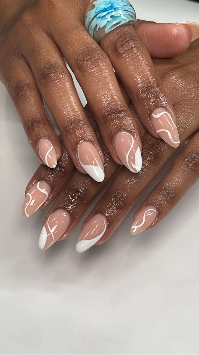 Chic Nude and Dramatic White Tip Nail Design with Artistic Flair