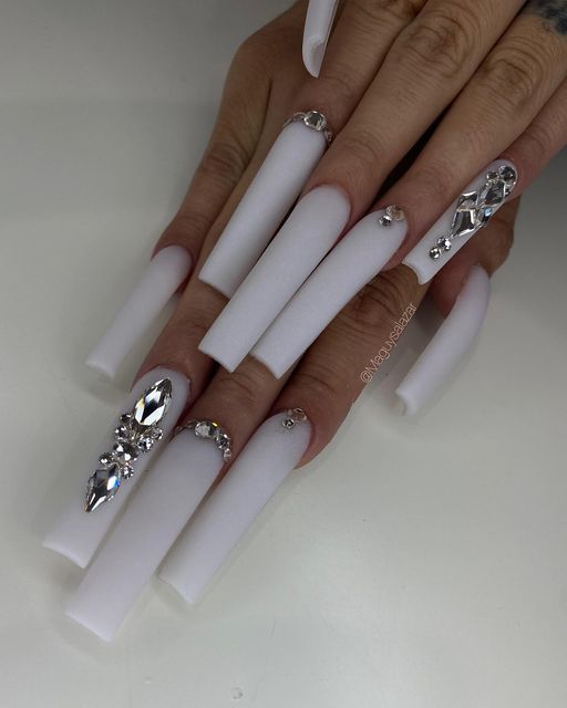 Elegant White Claw Nail Design with Rhinestones for a Bold Fashion Statement.