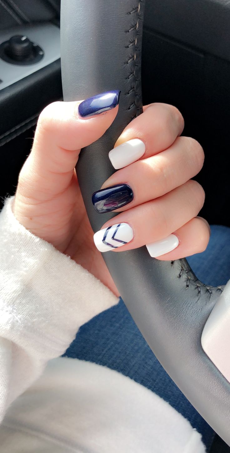 Chic Modern Nail Design: Deep Navy and White with Geometric Patterns.