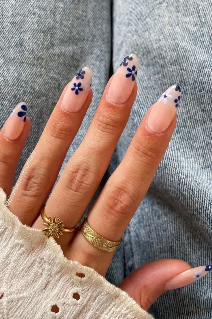 Elegant Floral Nail Design: Delicate Navy Blue Flowers on Transparent Pink Base