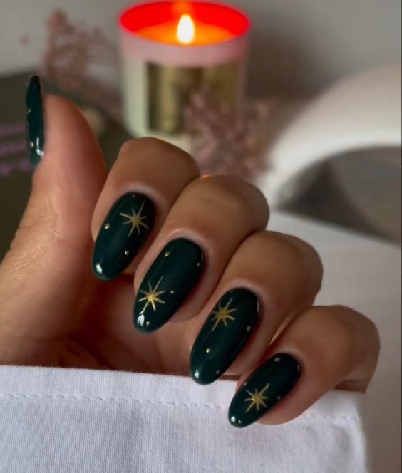 Glamorous Glossy Green Nail Design with Festive Gold Star Accents.