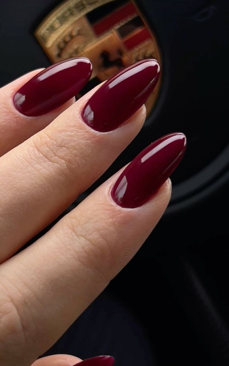 Sophisticated Deep Burgundy Almond-Shaped Nails: A Timeless Glamour Choice for Any Occasion.