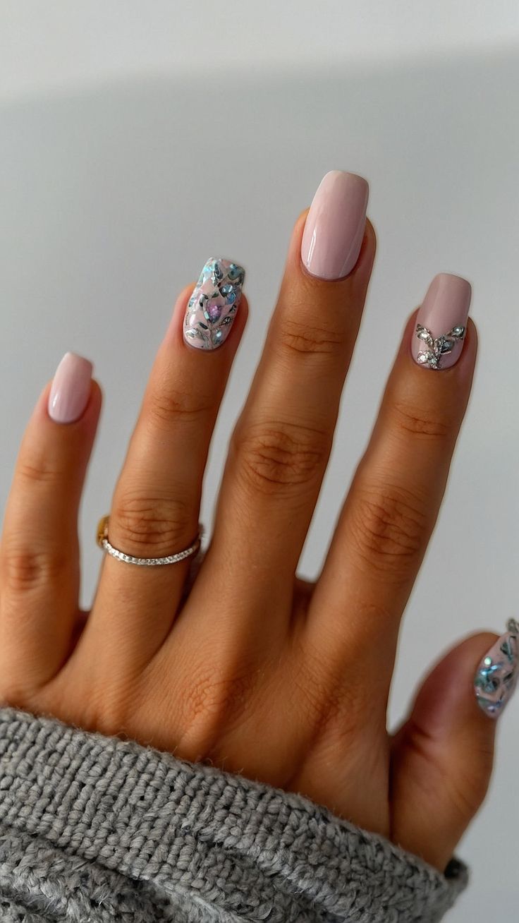 Elegant Chic Nail Design: Soft Pink Polish with Gem-Accented Accent Nails.