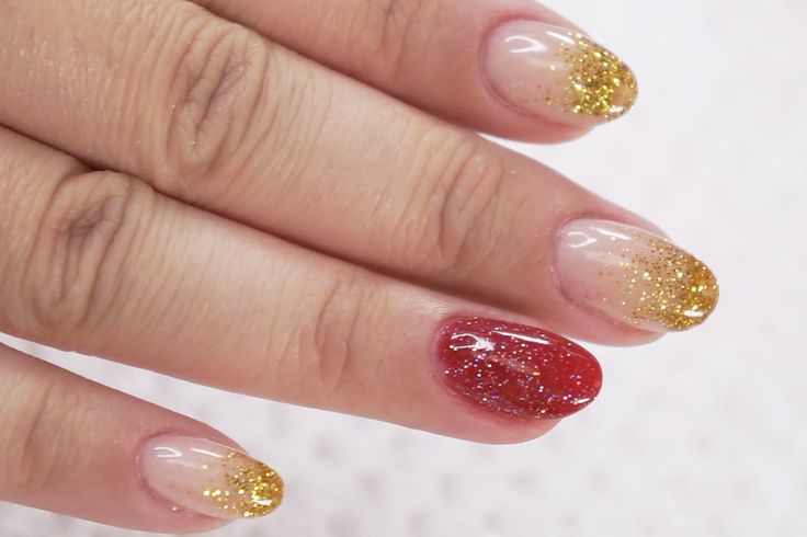 Glamorous Glitter Gradient Nail Design with Bold Tips and Vibrant Red Accent.