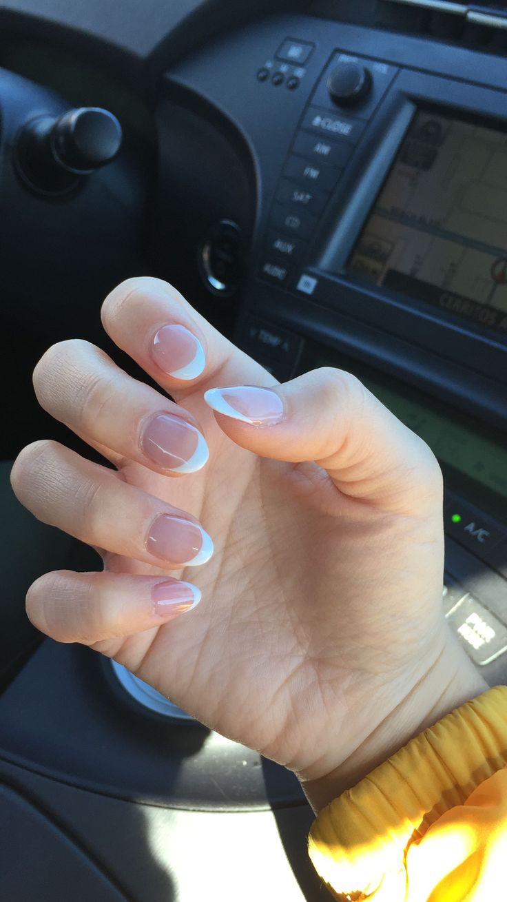 Sophisticated Nude and White French Tip Nail Design with Subtle Shimmer.