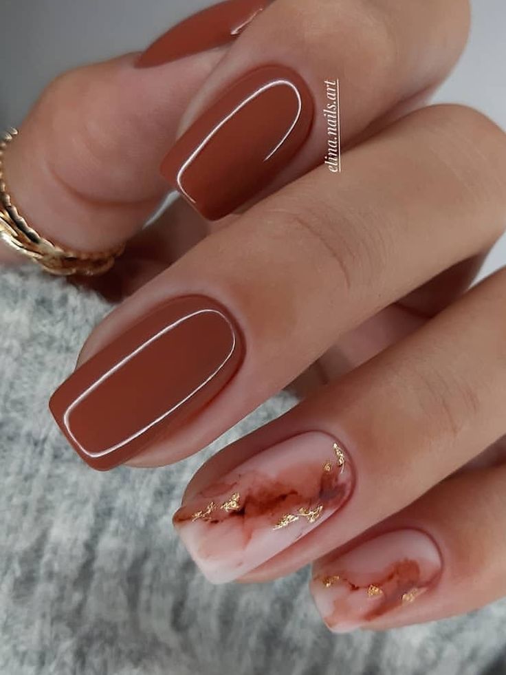 Sophisticated Brown Matte Nail Design with Pink and White Marble Accents and Gold Flakes.