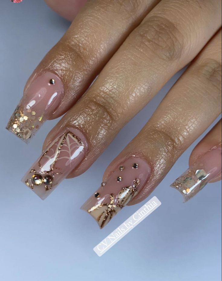 Sophisticated Nail Design: Nude Base with Glamorous Gold and Silver Accents