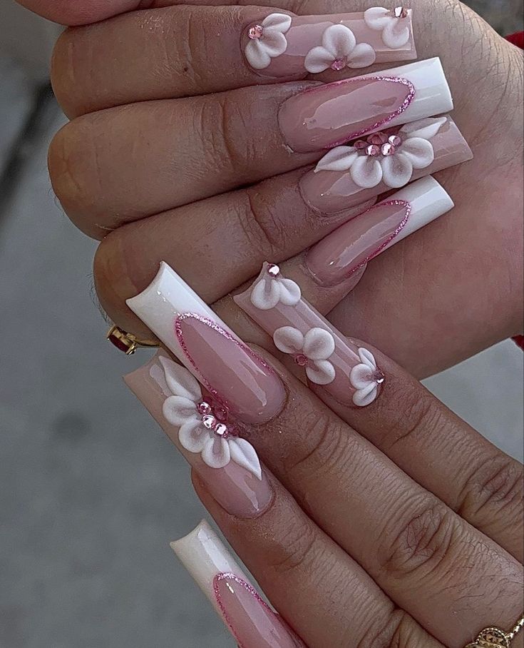 Whimsical Floral Nail Design with Three-Dimensional Flowers and Elegant Rhinestones.