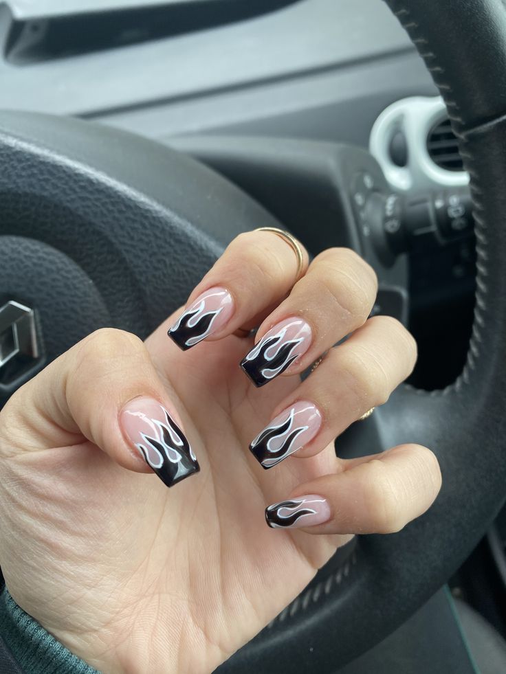 Flame-Inspired Nail Design: Bold Black Tips and Vibrant White Flames for a Modern Twist on French Tips.