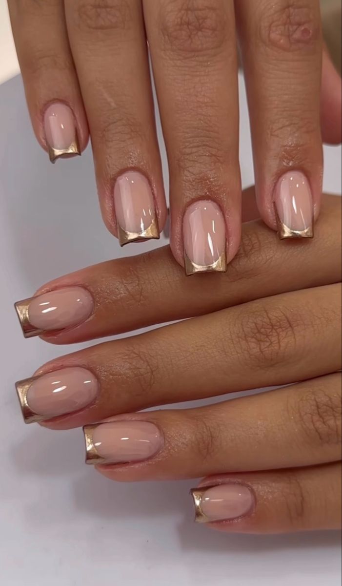 Chic Nude Nail Design with Striking Gold Triangular Tips.