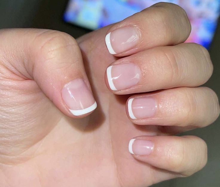 Timeless French Manicure: Classic White Tips on a Natural Nude Base for Effortless Chic.