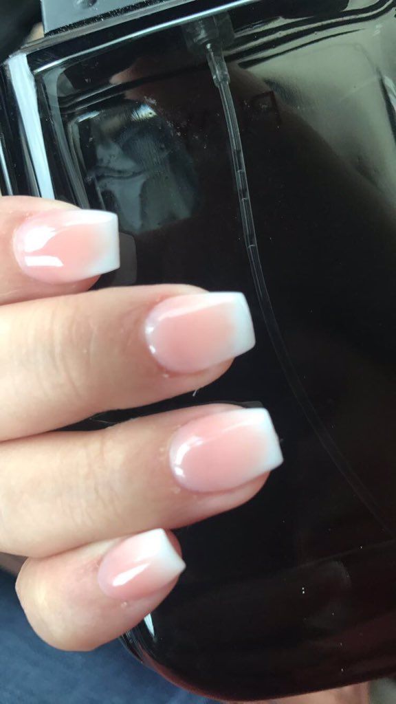 Sophisticated Ombre French Tips: A Classic Manicure Blending Soft Pink and Crisp White.