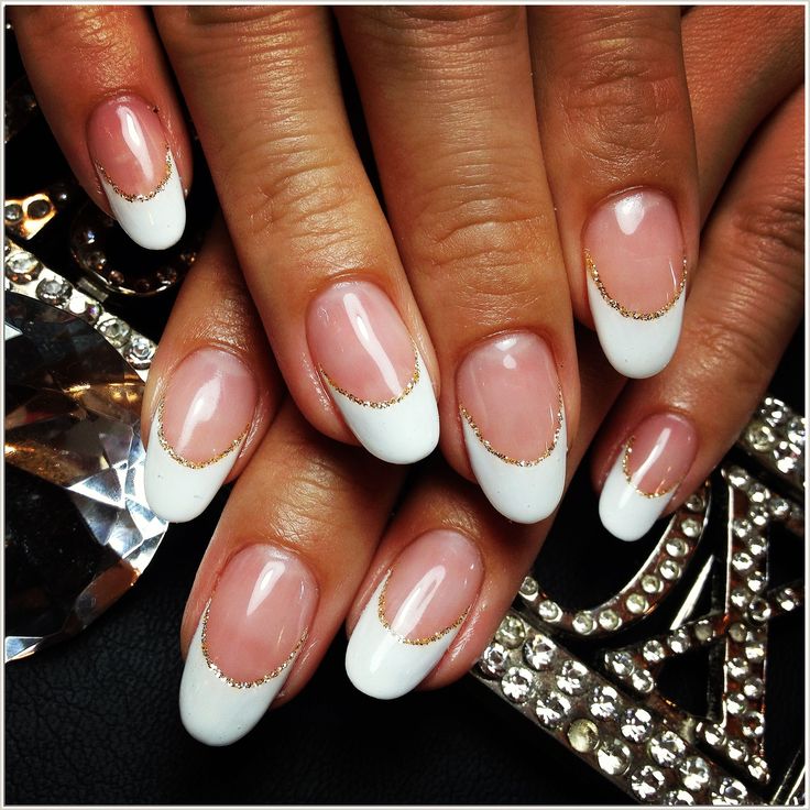 Chic French Manicure: Classic White Tips with Glamorous Gold Accents on Soft Pink Base.