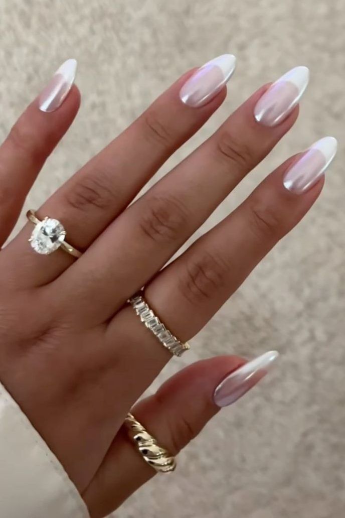 Elegant Ombre French Tip Nails with Delicate Rings for a Chic Aesthetic.