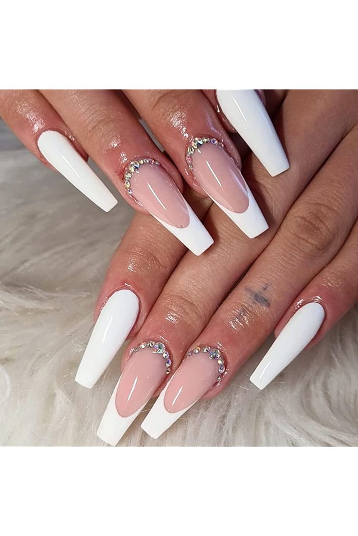 Sophisticated Nail Design: Long White Tips with Nude Base and Glamorous Rhinestones.