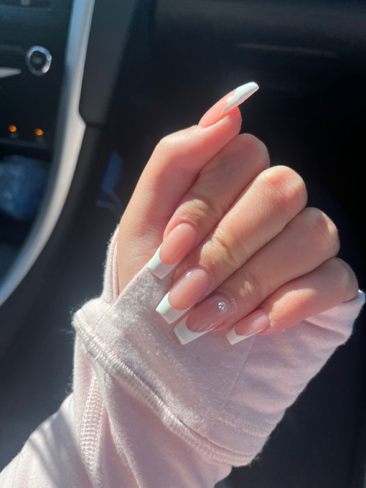 Chic Almond-Shaped Nail Design: Soft Pink and White Tips with Sparkling Accent.