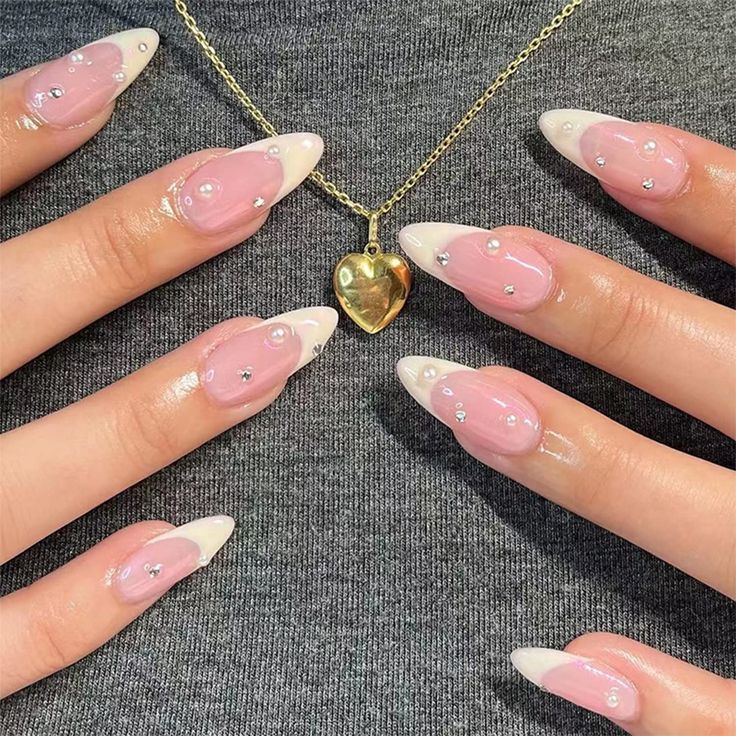 Chic Soft Pink and White Tip Nail Design with Rhinestone Accents.