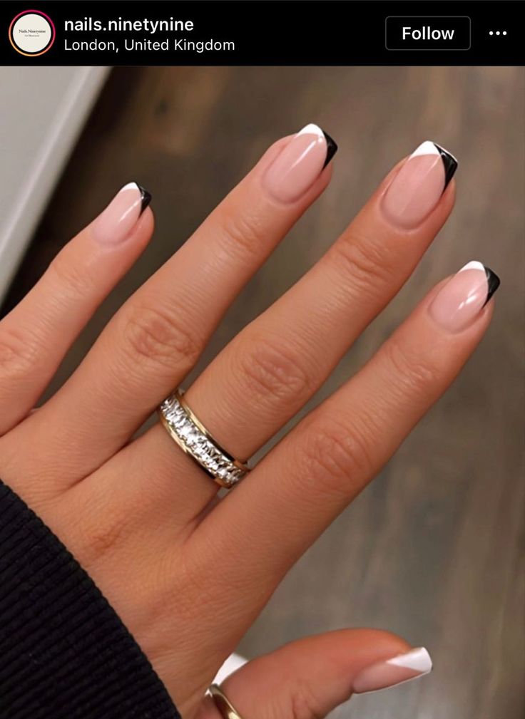 Sophisticated Nail Design: Modern French Manicure with Black Tips and Glamorous Rings.