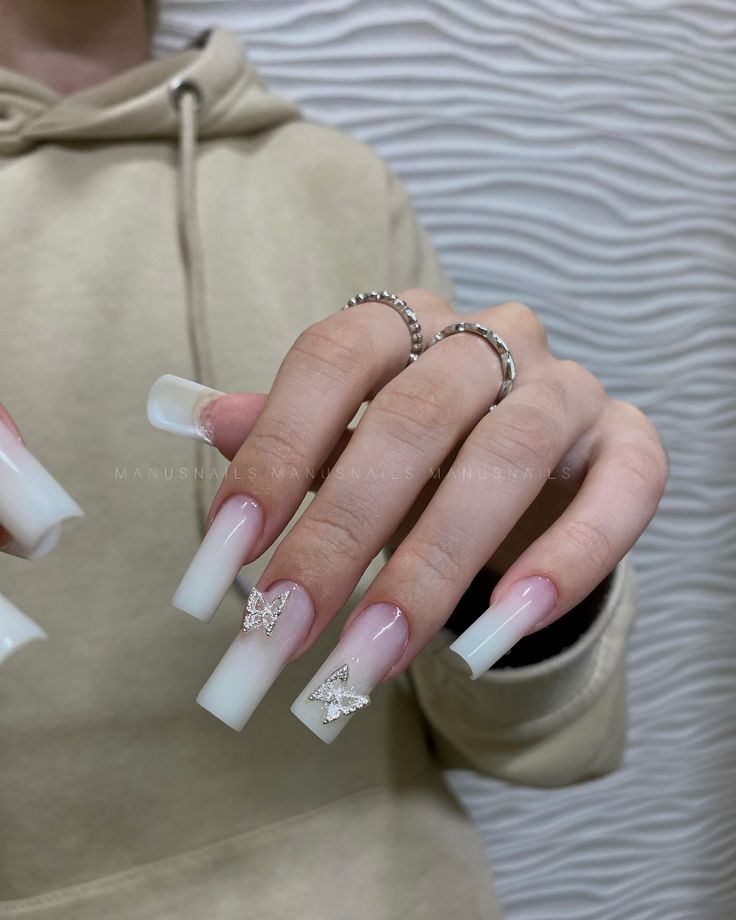 Elegant Ombre Long Nails with Butterfly Designs and Sparkling Accents