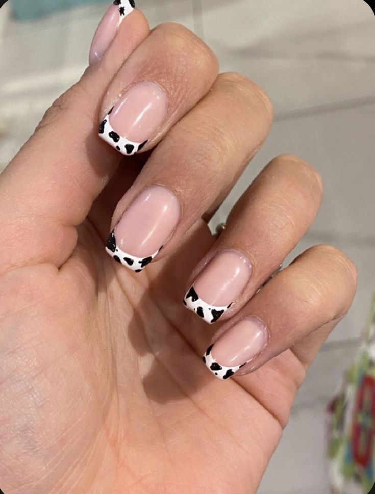 Playful Cow Print Nail Design: A Chic Twist on Classic French Manicure