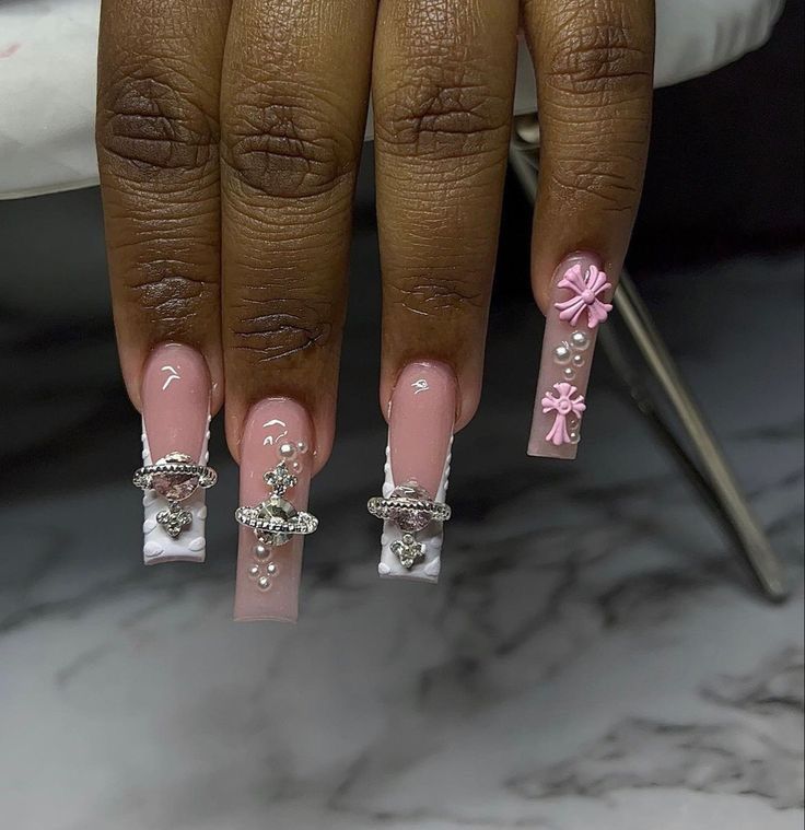 Elegant Long Nails: Soft Pink Base with Pearl and Bow Embellishments.