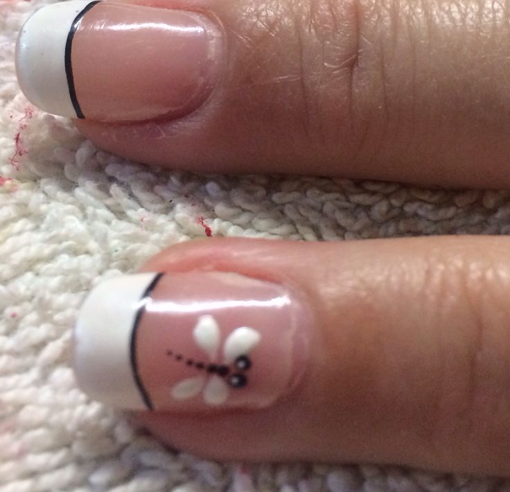 Elegant French Manicure with Floral Motif and Black Accents