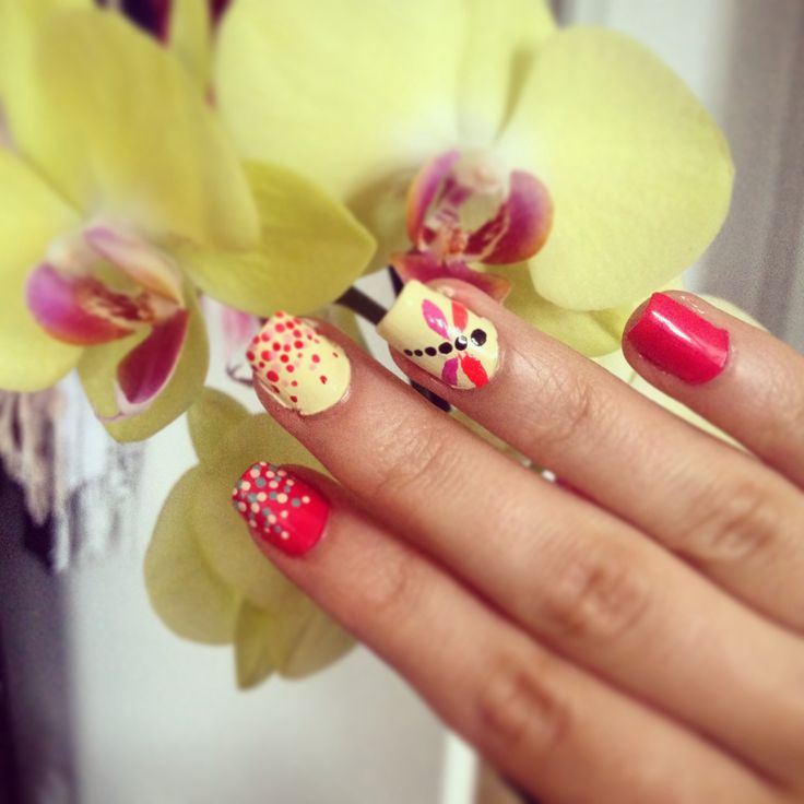 Bold Red and Playful Yellow Nail Design with Creative Accents and Floral Inspiration.