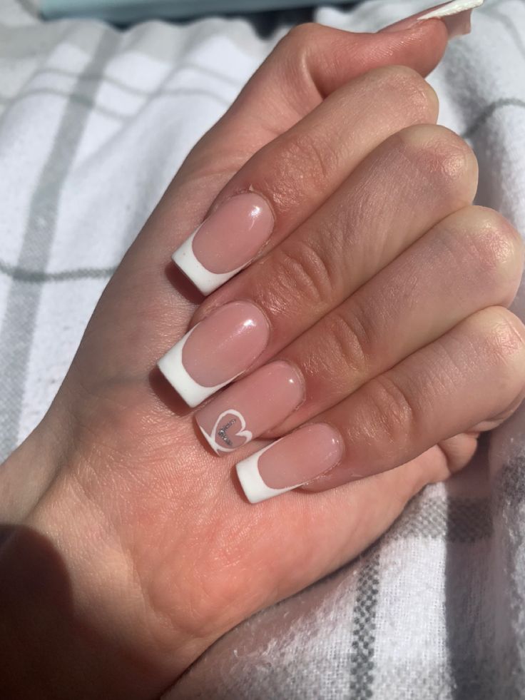 Chic French Manicure with Soft Pink Base, Crisp White Tips, and Heart Design.