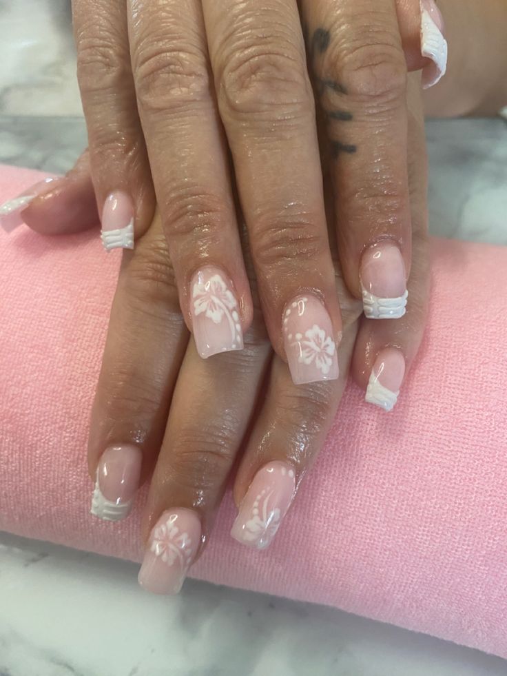 Elegant Floral Nail Design: Delicate White Flowers on Soft Pink Base for a Romantic Touch.