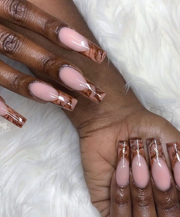 Elegant Soft Nude and Brown Tipped Nail Design with Subtle Marbling Effects.