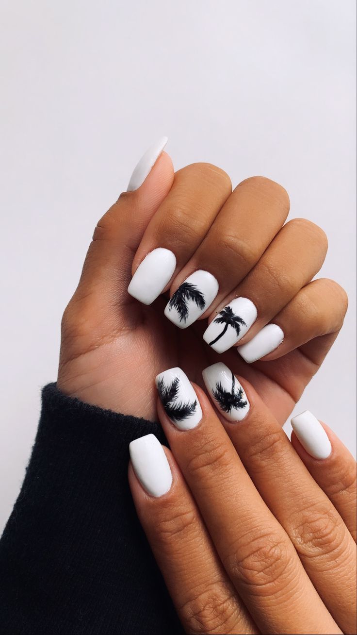 Tropical Chic: Glossy White Nails with Bold Black Palm Tree Silhouettes.