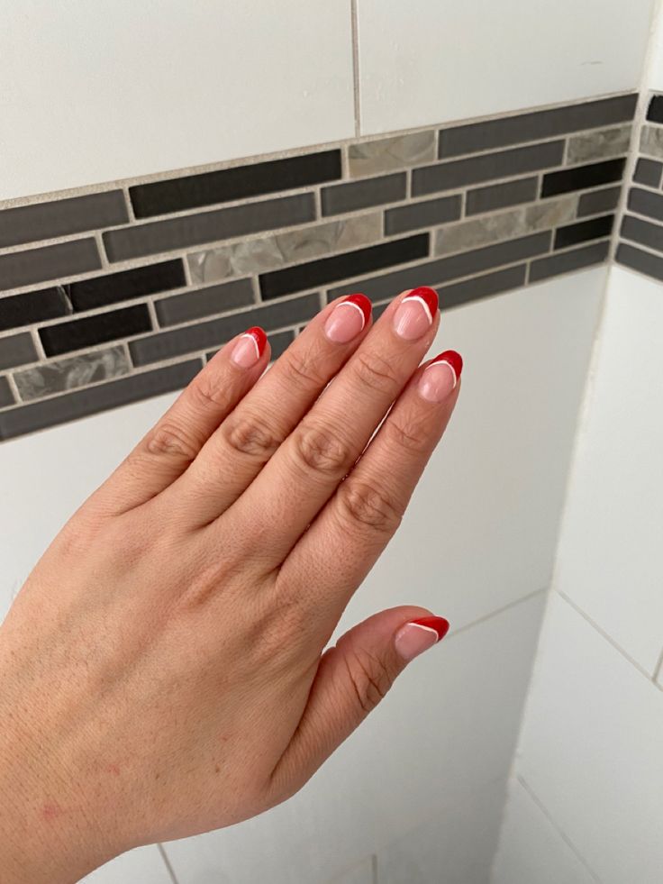 Sophisticated French Manicure with Bold Red Tips for a Modern Touch.