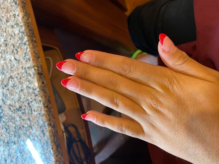 Bold Red-Tipped Elegant French Manicure: A Sophisticated Update.