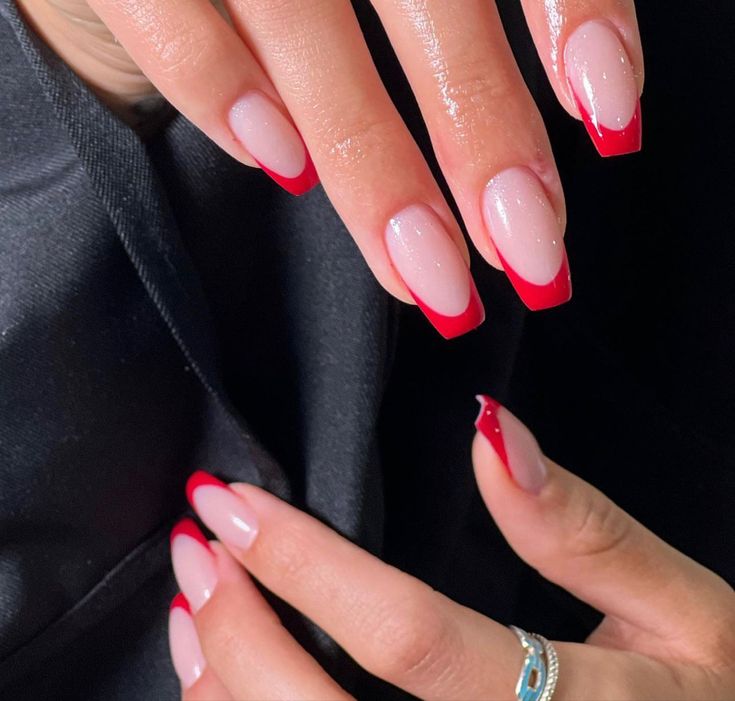 Chic Modern French Tip Nails: Ombre Pink Base with Bold Red Tips and Shimmer.