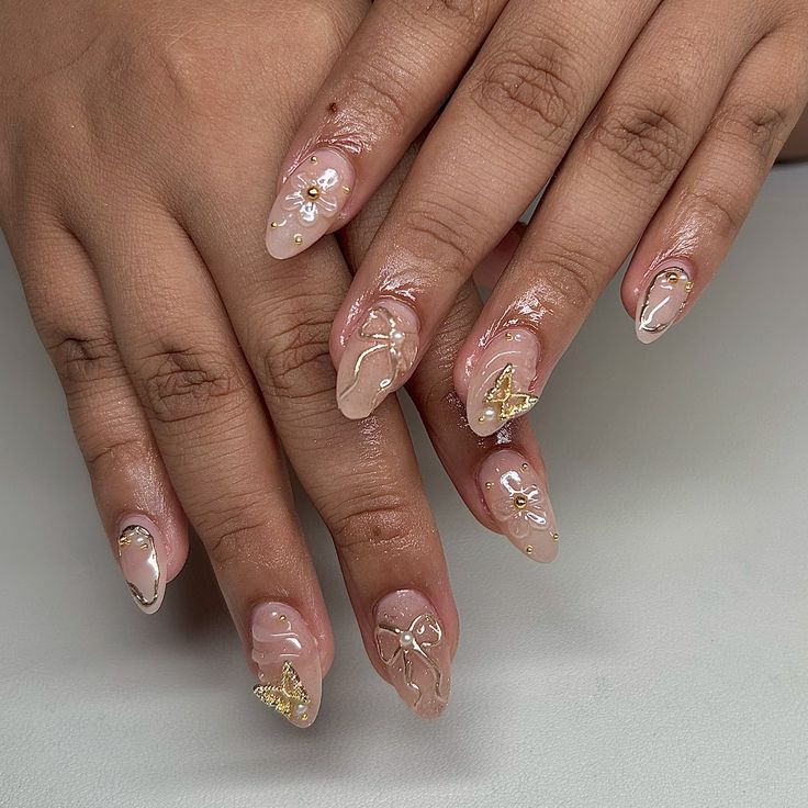 Elegant Nail Design: Soft Nude Base with Whimsical Butterfly Motifs and Gold Accents.