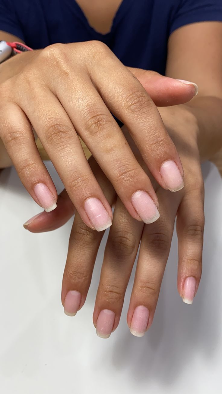 Elegant Nude Nails with Subtle French Tips for a Chic, Natural Look.