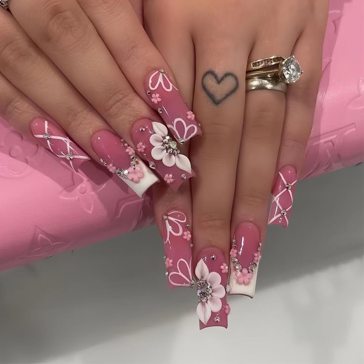 Chic Floral Nail Design with Soft Pink Base and Sparkling Accents